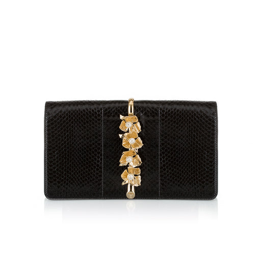 Designer evening clutch in black snakeskin with brass adornment