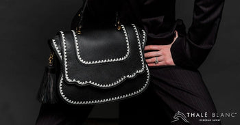 Audrey designer satchel in black leather with white stitching.