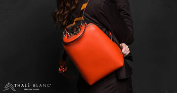 Orange designer backpack for women, with racerback straps.