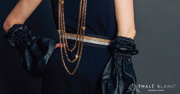 Luxury designer accessories, including crystal belt, vegan leather sleeves and gold chain layered necklace.
