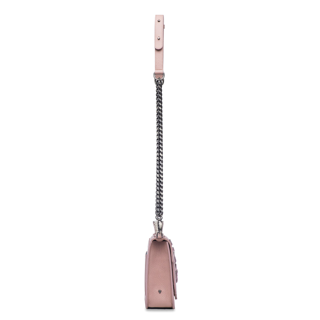 This best-selling top handle luxury leather bag in blush pebbled calfskin features both a detachable crossbody leather strap as shown and a detachable chain strap. Make it your own with a fur Duma Hok-Pom or our signature leather tassel or opt for one of our leather guitar straps for an on-trend look. It is one of the easiest to accessorize handbags.