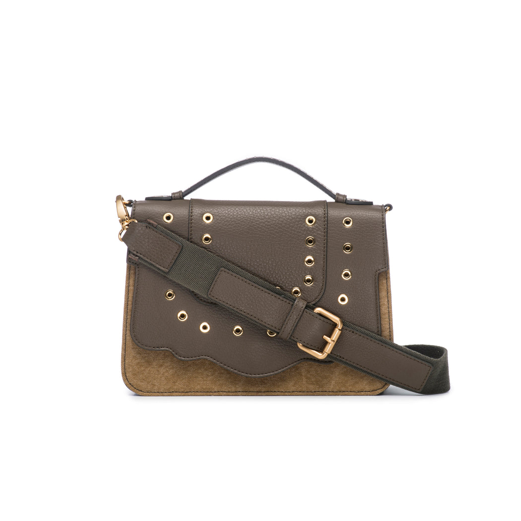 This best-selling top handle luxury leather bag in military green calfskin and canvas features a detachable crossbody leather and fabric strap. The front flap is adorned with gold-toned eyelets for a decorative touch. Make it your own with a fur Duma Hok-Pom or our signature leather tassel or opt for one of our leather guitar straps for an on-trend look. It is one of the easiest to accessorize handbags.