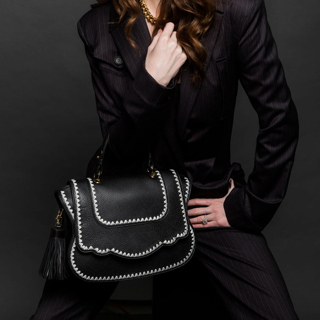 Women's designer satchel in black leather with white trim
