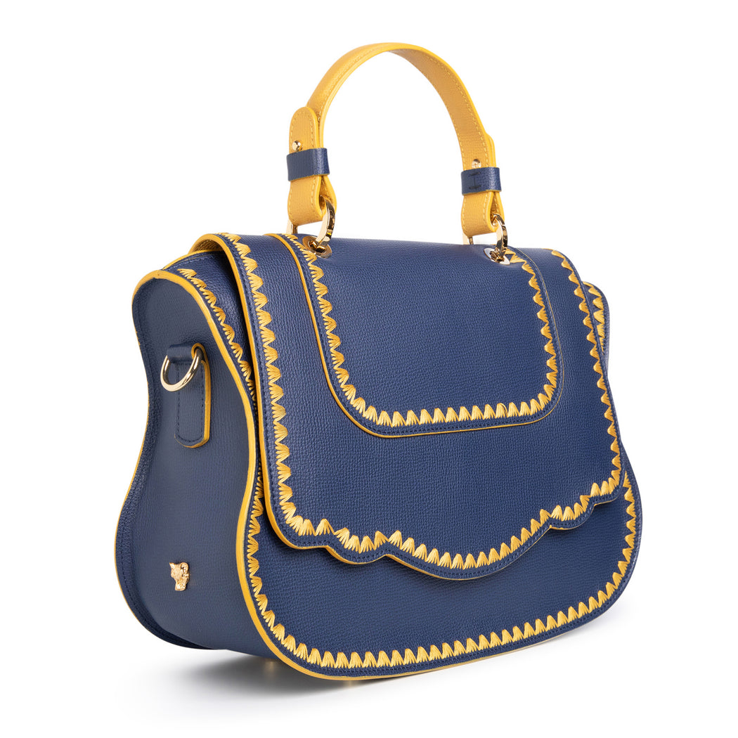 Women's designer handbag in blue leather with yellow stitching.