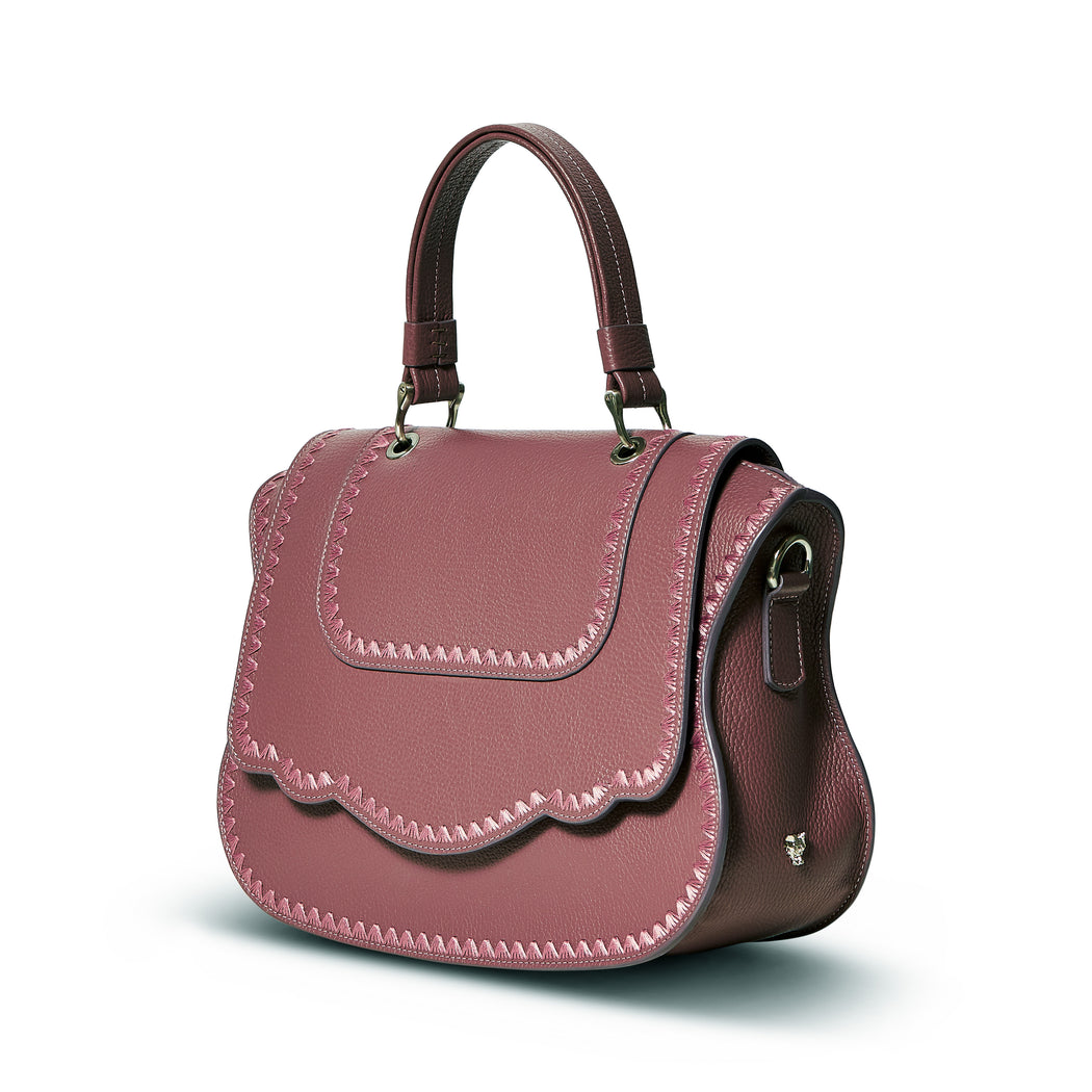 An instant statement luxury leather bag in balsamic grained calfskin, the feminine curved lines and spacious interior ensures that the bag is both chic and functional. Can be comfortably worn on the shoulder as it features a removable shoulder strap. The signature curved flap is highlighted with beautiful crowfeet tonal stitching.